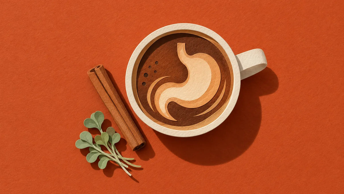 A paper-cut pumpkin spice latte seen from above, its foam swirl shaped like a stomach, beside a cinnamon stick on terracotta paper